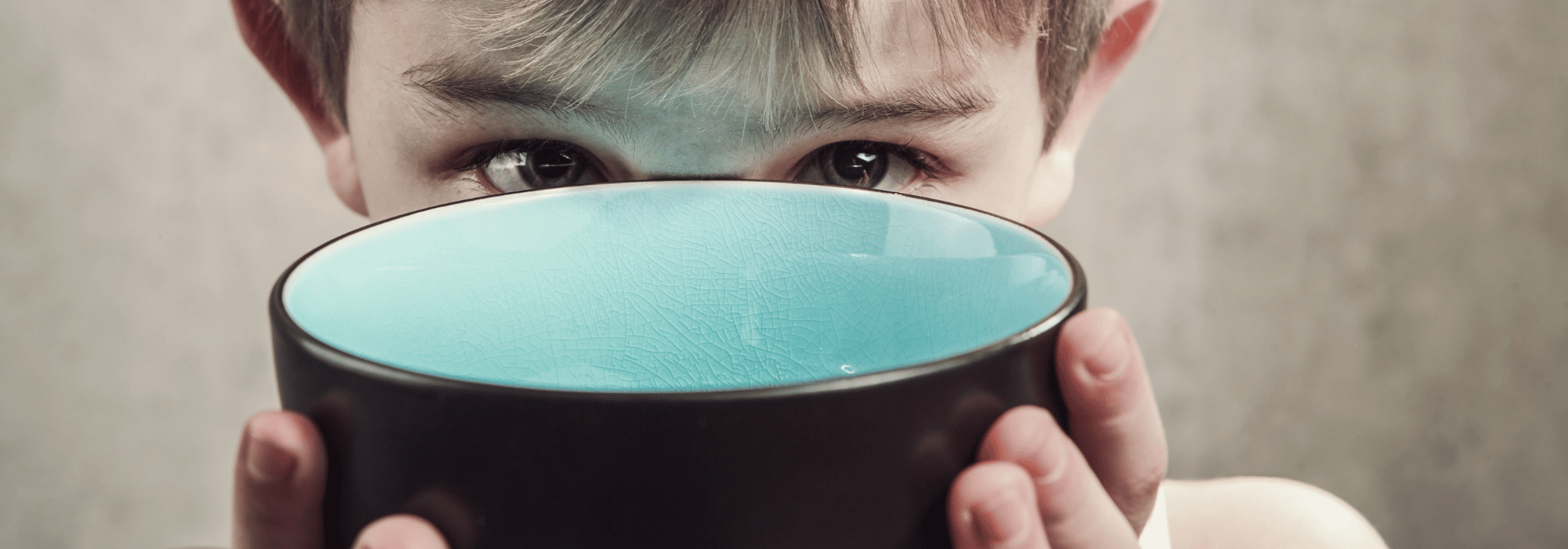 Boy holding an empty bowl